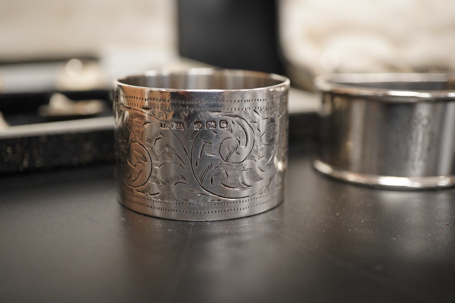 Two cased sets of six mid 20th century silver coffee spoons including Barker Brothers Silver Ltd, Birmingham, 1940, together with a silver and sterling napkin rings and a silver tea strainer on stand.